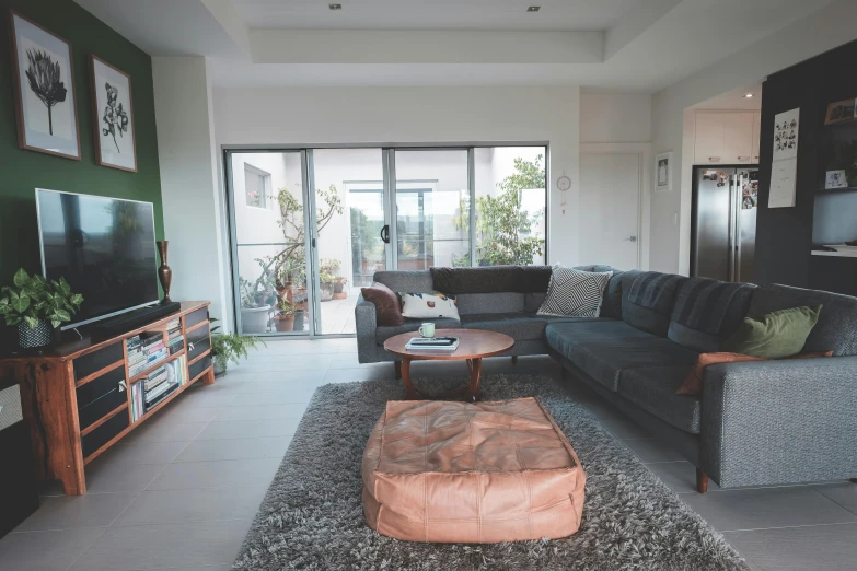 a living room filled with furniture and a flat screen tv, unsplash, light and space, “ iron bark, high details photo, cinematic footage, wide angle establishing shot