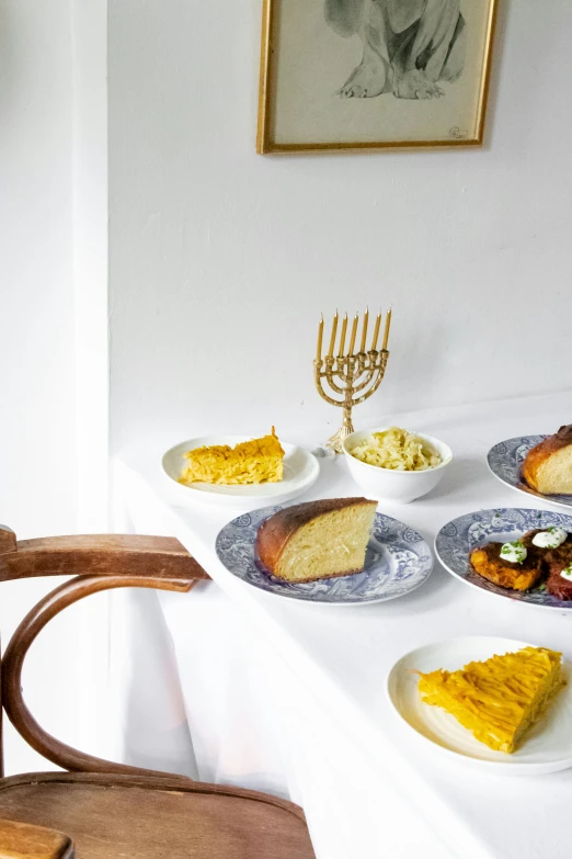 a number of plates of food on a table, by Daniel Lieske, sukkot, cake, with a white background, good light