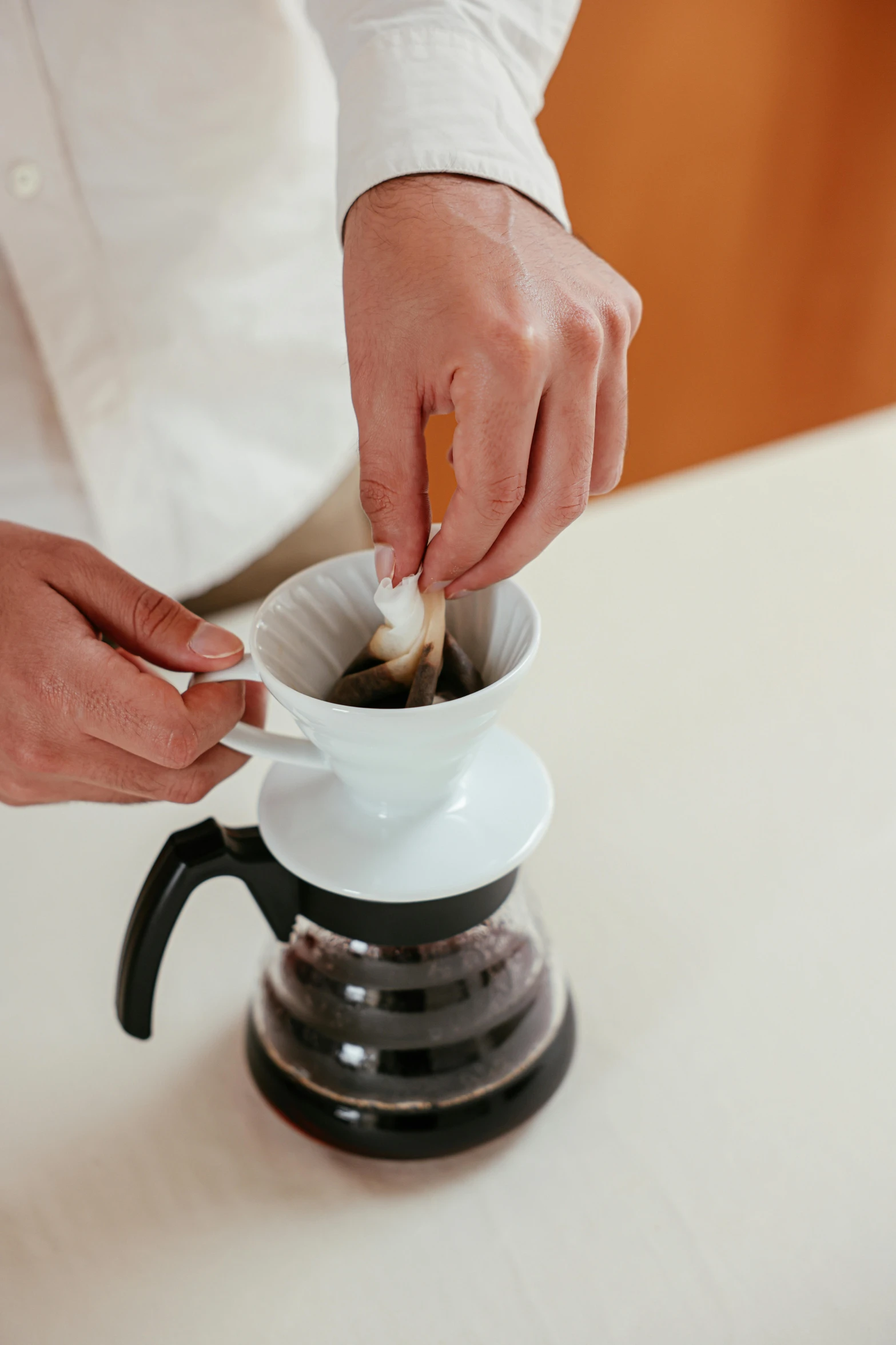 a person pours coffee into a cup, by Julia Pishtar, coated pleats, blending, guide, very crispy