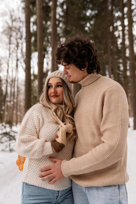 a man and woman standing next to each other in the snow, trending on pexels, renaissance, maternity feeling, beige, curls, thumbnail