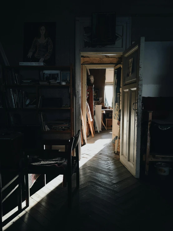 an open door leading into a dark room, a photorealistic painting, inspired by Vasily Perov, unsplash contest winner, light and space, inside a cluttered art studio, instagram story, sunlight shining through windows, polish mansion kitchen