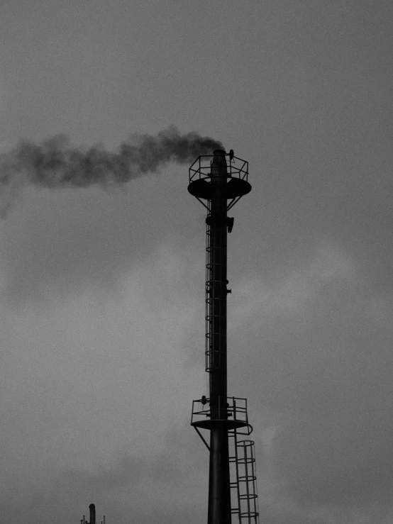 a black and white photo of smoke coming out of a chimney, a black and white photo, by Shinji Aramaki, myllypuro water tower, silhouette!!!, industrial colours, one single gas lamp