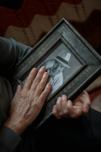 a close up of a person holding a picture, heartbreaking, two hands, uploaded, stillframe