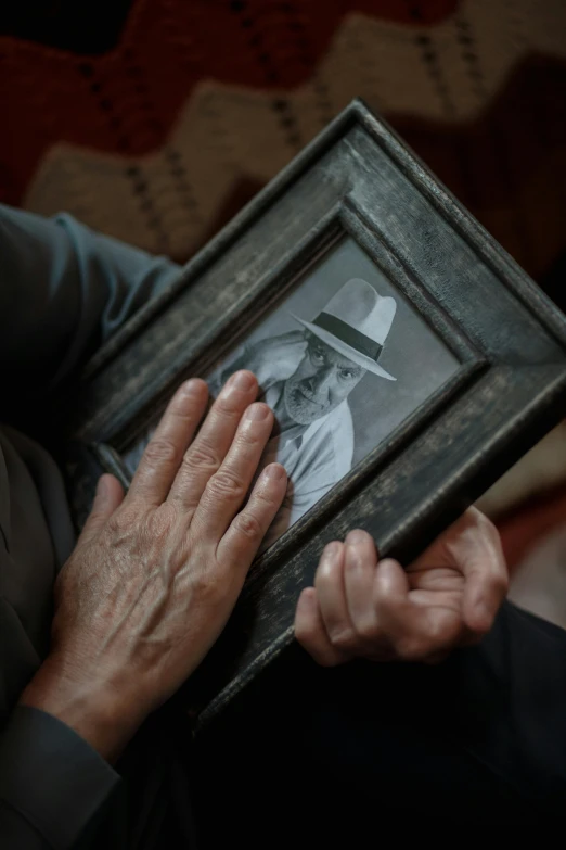 a close up of a person holding a picture, heartbreaking, two hands, uploaded, stillframe