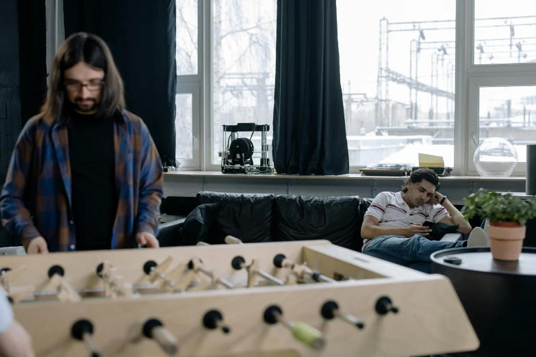 a man standing in front of a foo foo foo foo foo foo foo foo foo foo foo, a picture, by Jaakko Mattila, pexels contest winner, arbeitsrat für kunst, lawther sit at table playing dnd, two buddies sitting in a room, robotics, cinematic full shot