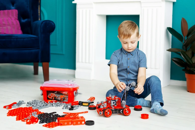 a little boy sitting on the floor playing with legos, by Julian Hatton, pexels contest winner, constructivism, red and black robotic parts, playing with a small firetruck, with gears and tubes, blippi