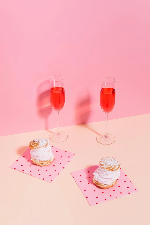 a couple of cupcakes sitting on top of a pink table, bubbly, with a drink, visually crisp & clear, snacks