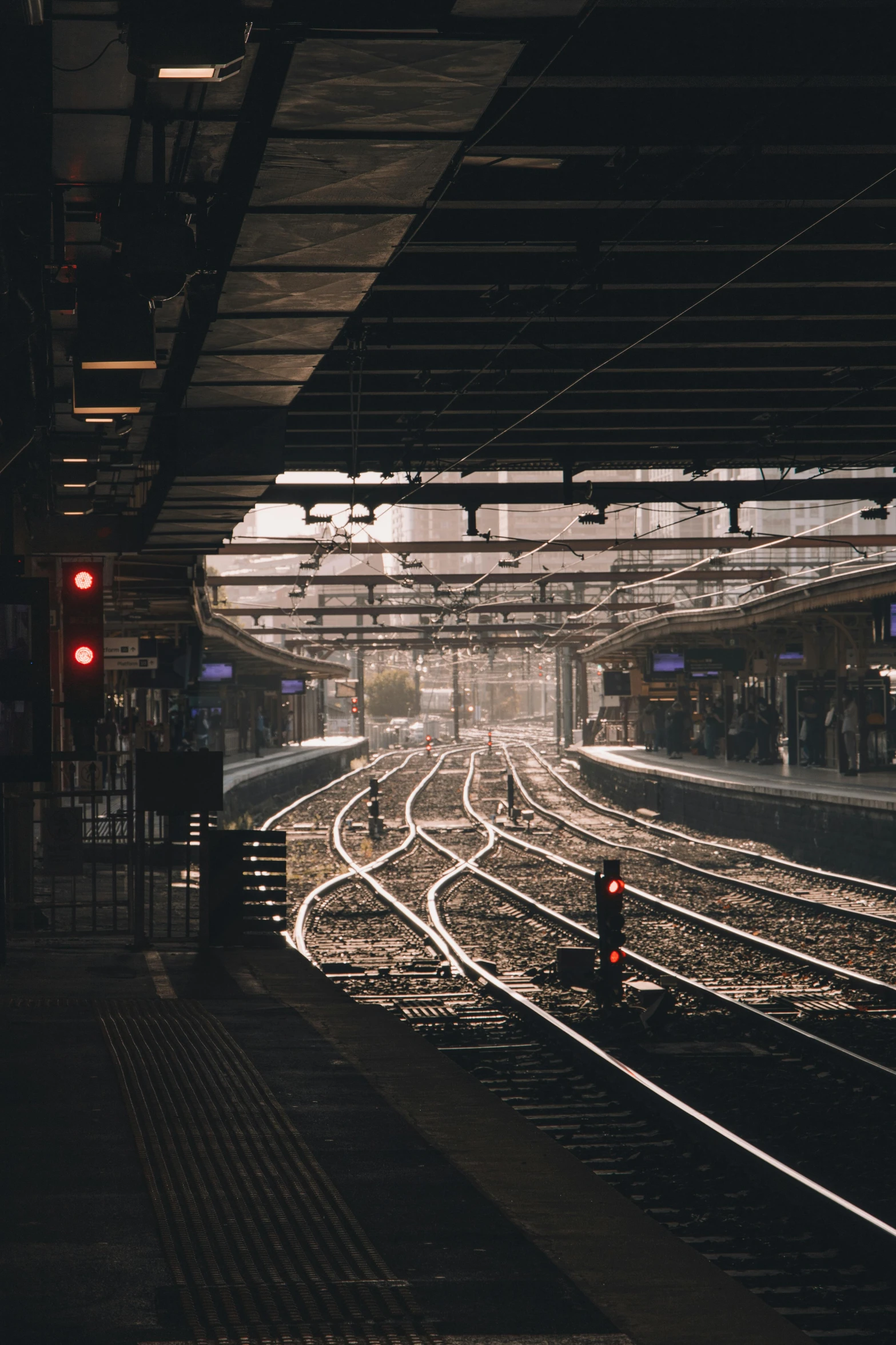 a train station with a train on the tracks, by Daniel Seghers, unsplash contest winner, soft light dull mood, square lines, city morning, platforms