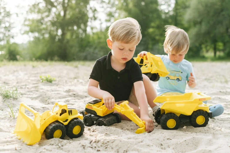 two young boys playing in the sand with construction vehicles, a picture, hansa yellow, fully posable, press shot, lifestyle