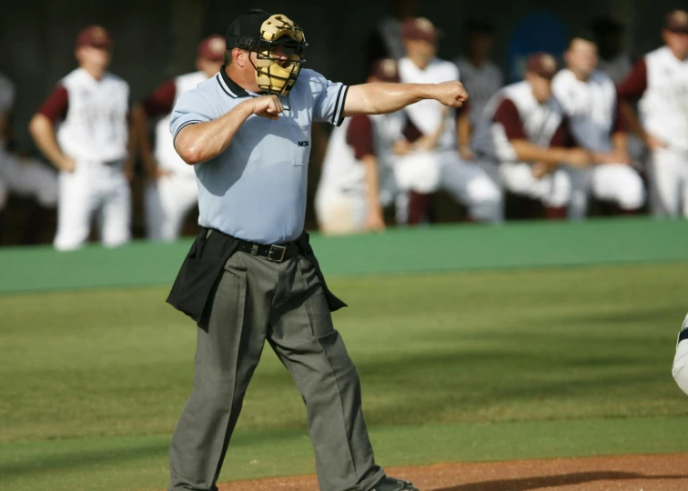 a man standing on top of a baseball field, yelling, chest guard, brown, instruction