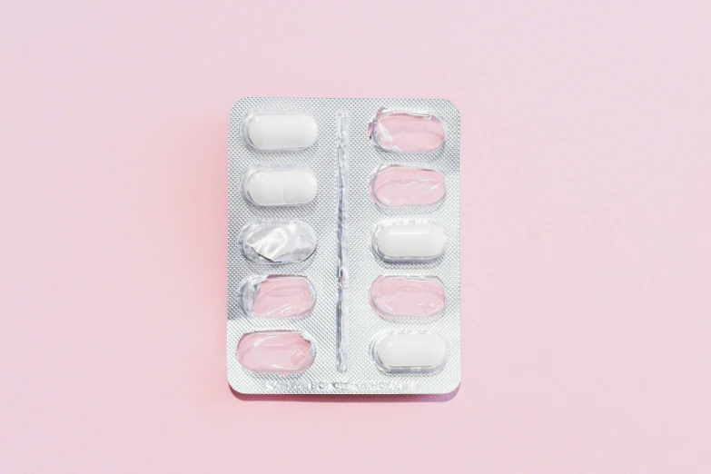 pills in a blister pack on a pink background, by Nicolette Macnamara, asset on grey background, instagram post, white hue, feminine looking