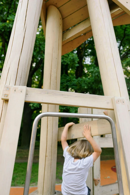 a little boy standing on top of a wooden structure, by karlkka, bottom body close up, wooden supports, slides, subtle detailing