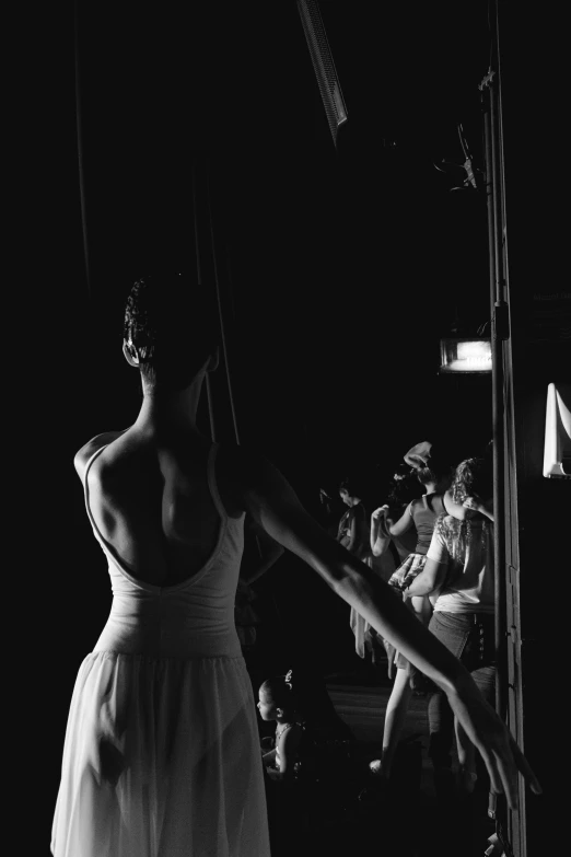 a black and white photo of a woman in a dress, by Elizabeth Polunin, pexels contest winner, arabesque, fashion week backstage, wearing white leotard, theater dance scene, summer night