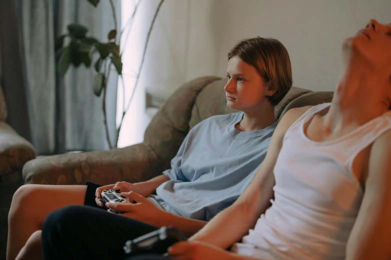 a couple of people sitting on top of a couch, pexels, hyperrealism, video games, movie still of a tired, woman is sitting, ( ( theatrical ) )