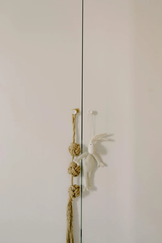 a close up of a mirror with a bird on it, inspired by Cerith Wyn Evans, new sculpture, hanging rope, doors to various bedrooms, ayamin kojima, minimal palette