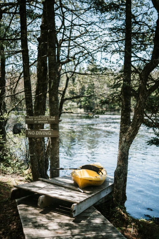 a yellow boat sitting on top of a wooden dock, les nabis, forest picnic, a mystic river, photograph, small canoes