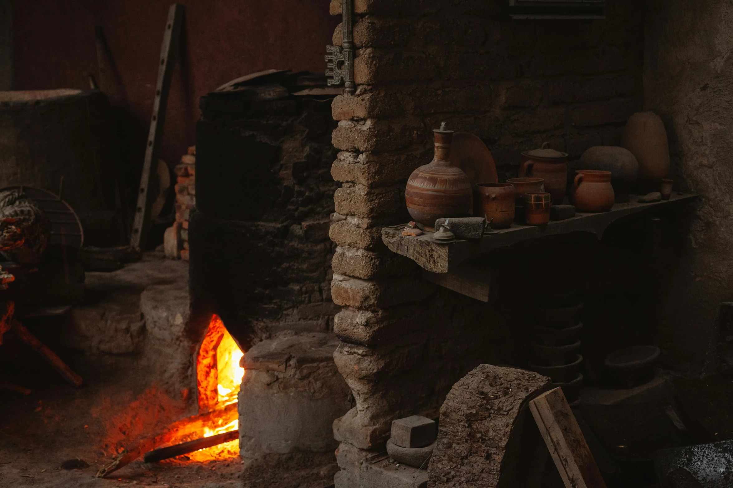 a kitchen with a fire in the middle of it, a portrait, pexels contest winner, renaissance, terracotta, ancient persian temple dungeon, profile image, old village