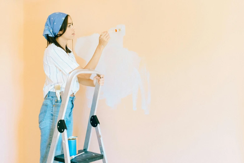 a woman standing on a ladder painting a wall, a minimalist painting, trending on pexels, pastel colours, a young asian woman, youtube thumbnail, background image