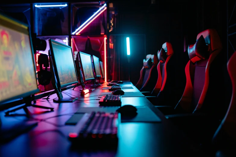 a row of computer monitors sitting on top of a desk, cyberpunk art, pexels, e-sport style, purple and red, neon blue and yellow lights, mobile game