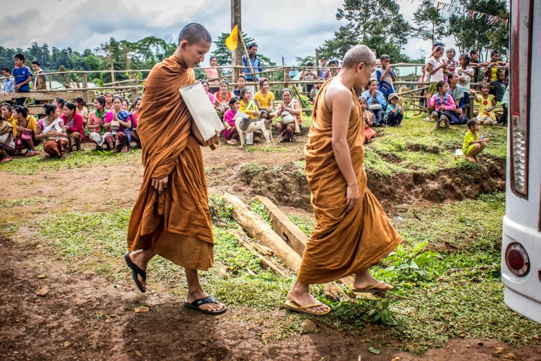 a couple of monks walking down a dirt road, ayahuasca ceremony, carrying a tray, profile image, maintenance photo