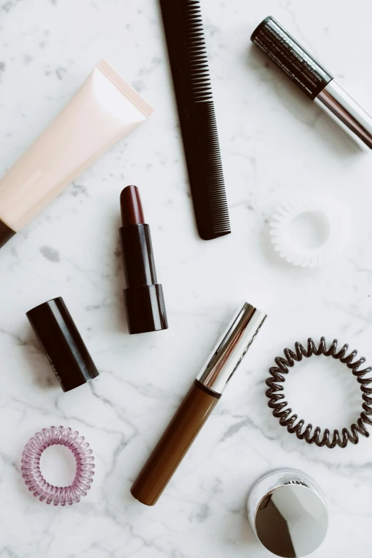 various beauty products laid out on a marble surface, trending on pexels, thin pursed lips, brown, lacey accessories, monochromatic