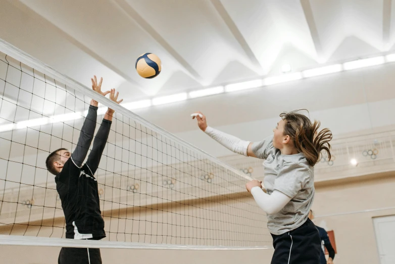 a couple of women playing a game of volleyball, unsplash contest winner, arabesque, tall ceilings, profile image, thumbnail, 🦩🪐🐞👩🏻🦳