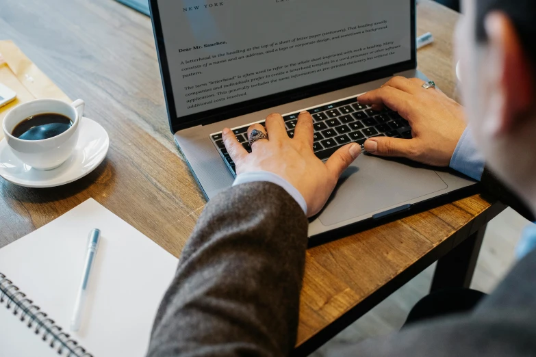 a man is typing on a laptop computer, by Carey Morris, trending on unsplash, sitting on a mocha-colored table, technical document, background image, round format