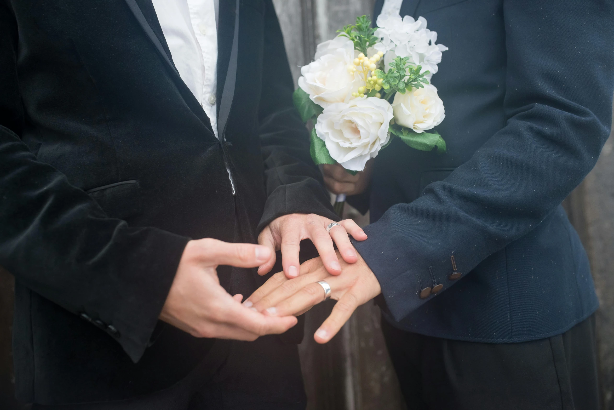 a close up of a person putting a ring on another person's finger, an album cover, formal attire, pierre pellegrini and ash thorp, multi - coloured, bouquets