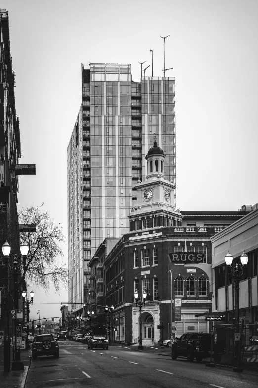 a black and white photo of a city street, by Dave Melvin, unsplash contest winner, buildings made out of glass, old west, two towers, yeg