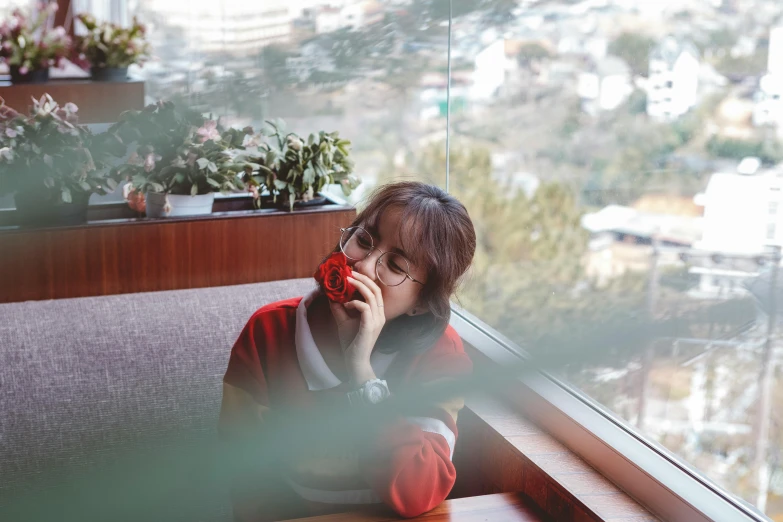 a woman sitting on a couch talking on a cell phone, inspired by Kim Jeong-hui, pexels contest winner, ulzzang, cafe in the clouds, wearing red, profile image