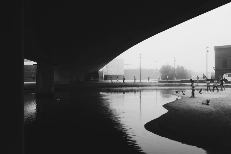 a black and white photo of people walking under a bridge, a black and white photo, unsplash contest winner, minimalism, fog and swans over the river, selfie photo, high contrast 8k, world of only concrete