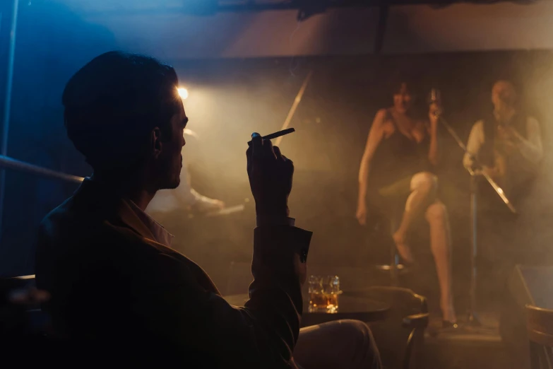 a man smoking a cigarette in a dimly lit room, inspired by Nan Goldin, pexels contest winner, figuration libre, 3 actors on stage, stage at a club, ( ( theatrical ) ), ilustration