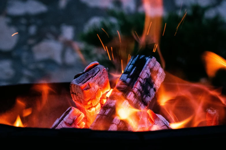 a close up of a fire in a grill, pexels contest winner, barrel fires and tents, himalayan rocksalt lamp, cosy fireplace, burning wings