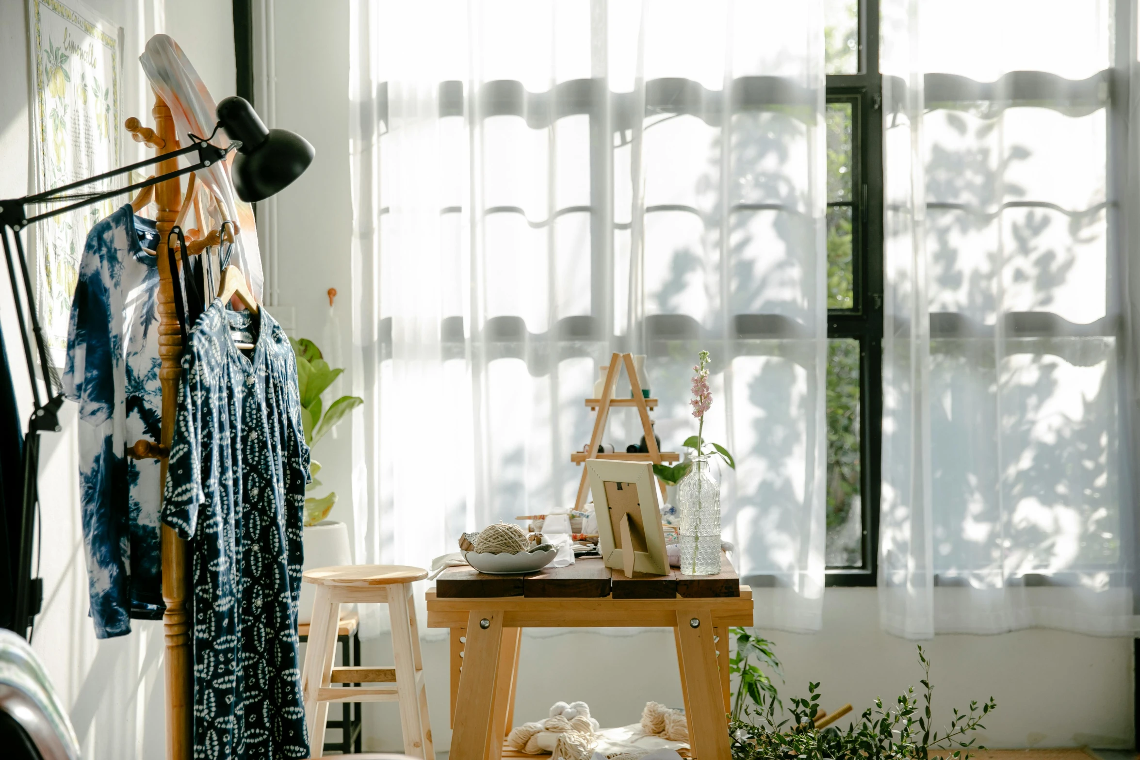 a living room filled with furniture and a window, inspired by Sawa Sekkyō, unsplash, light and space, fashion studio, curtains, wearing a camisole and shorts, interior of a small room