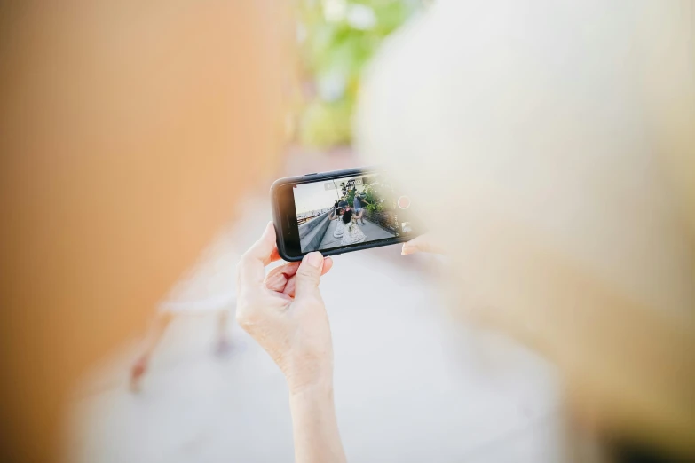 a woman taking a picture with her cell phone, by Tom Bonson, unsplash, overexposed photograph, multiple stories, b - roll, top - down photograph