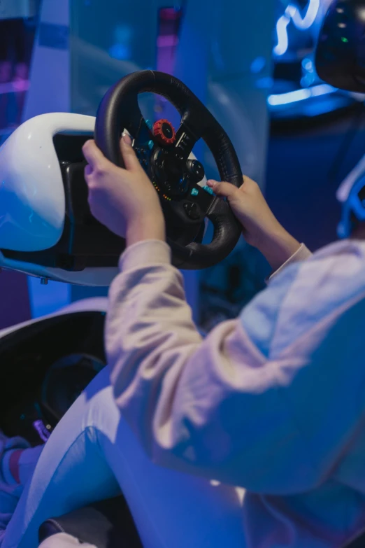 a person playing a video game with a steering wheel, up-close, immersive, 000 — википедия