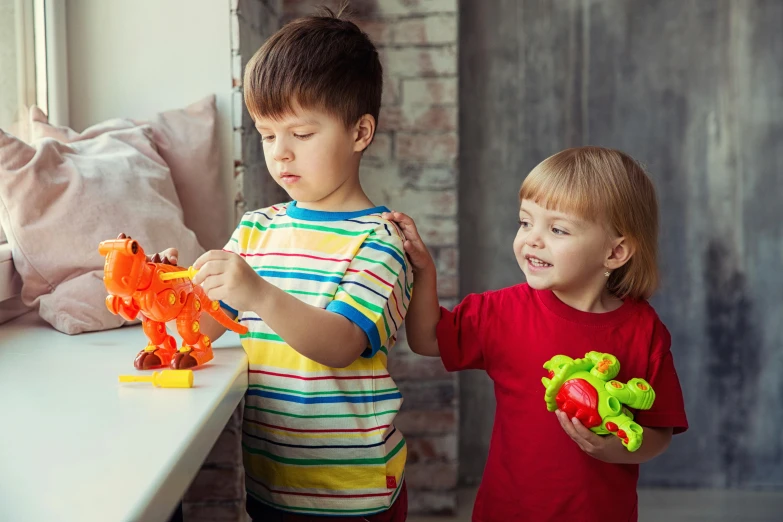 a couple of kids standing next to each other, plastic toy, dinosaurs, instruction, knick knacks