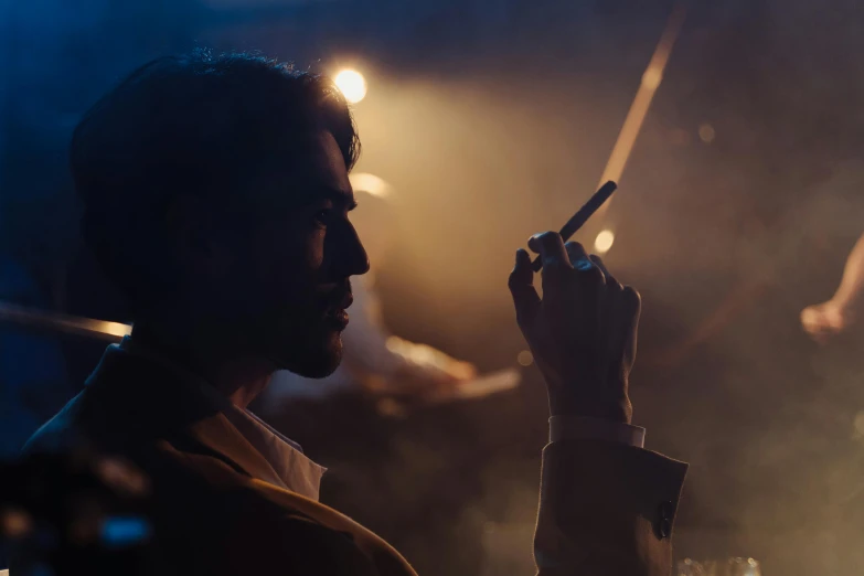 a man smoking a cigarette in a dark room, inspired by roger deakins, pexels contest winner, figuration libre, flares anamorphic, looking at his phone, worksafe. cinematic, cinestill colour