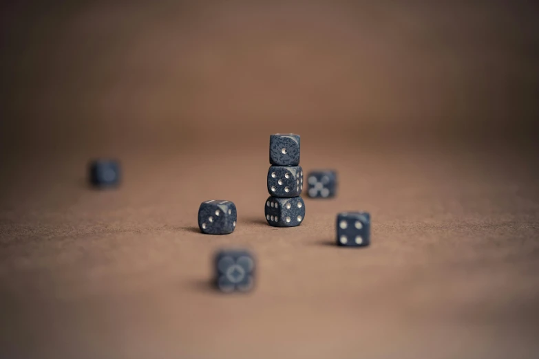 a pile of dice sitting on top of a table, a macro photograph, by Adam Pijnacker, unsplash, photorealism, indigo, grey, made of dots, eight eight eight