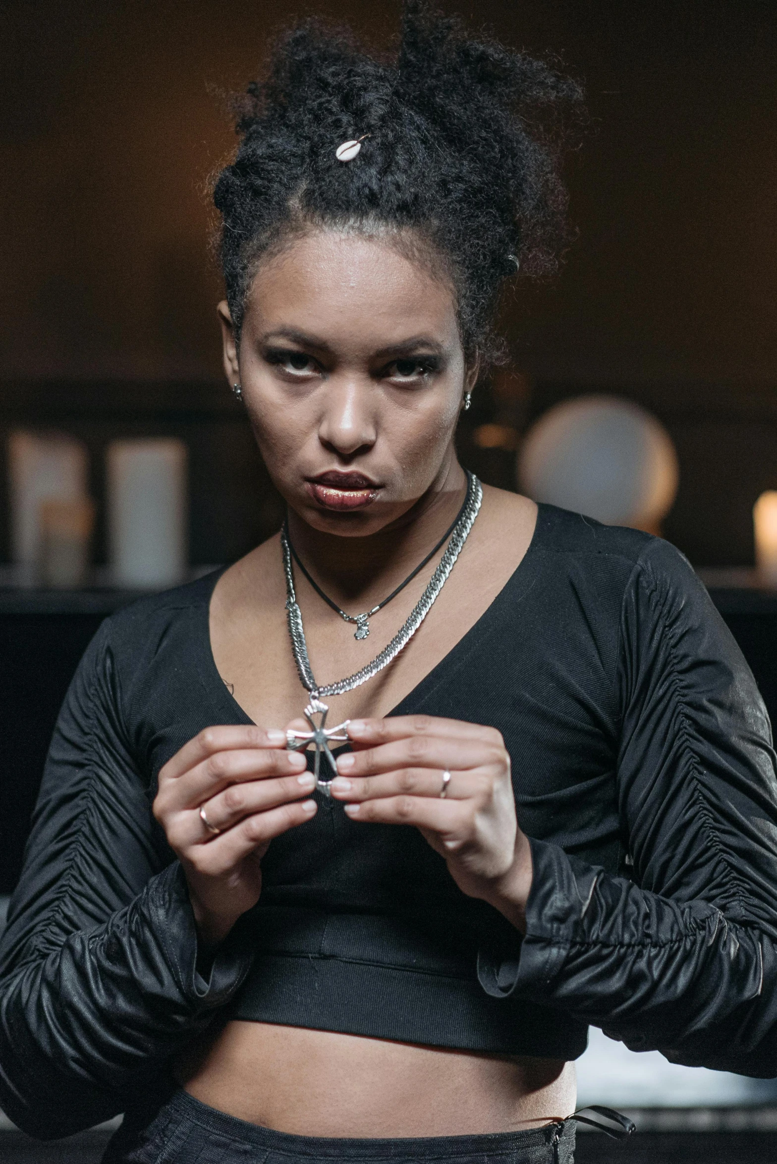 a woman in a black top and leather pants, a portrait, unsplash, renaissance, black magic crystal ring, mixed-race woman, wearing several pendants, film still dnd