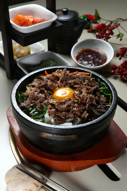 a bowl of food sitting on top of a table, mingei, bowl filled with food