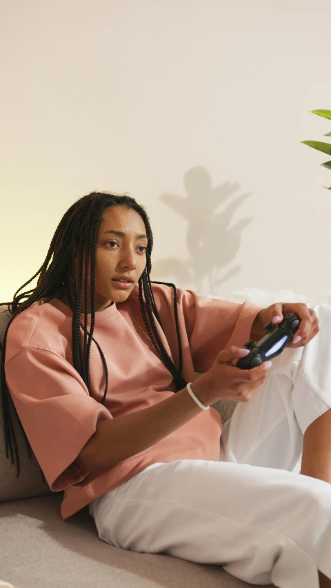 a woman sitting on a couch holding a remote control, ashteroth, nintendo game, instagram photo, press shot