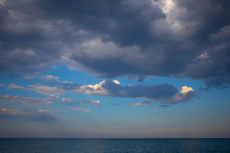 a large body of water under a cloudy sky, a picture, unsplash, mediterranean, medium format. soft light, greg rutwoski, ignant