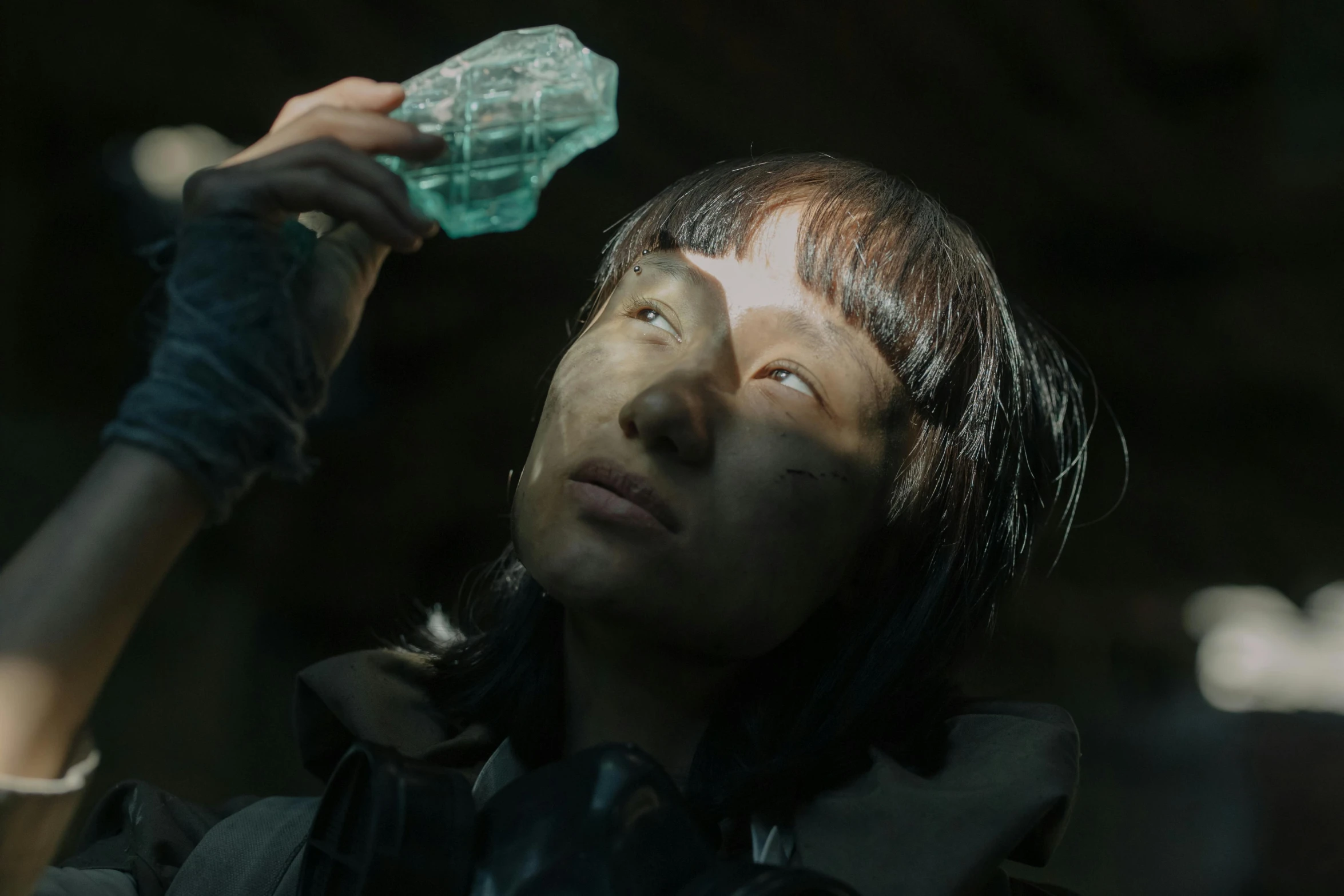 a close up of a person holding a bottle, a hologram, inspired by Liam Wong, featured on zbrush central, cave crystals, asian woman made from origami, still from a ridley scott movie, cast glass