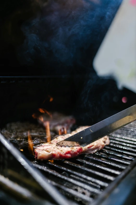 a person is cooking meat on a grill, by Matt Cavotta, pexels contest winner, renaissance, instagram story, sharp detail, multi - layer, blues