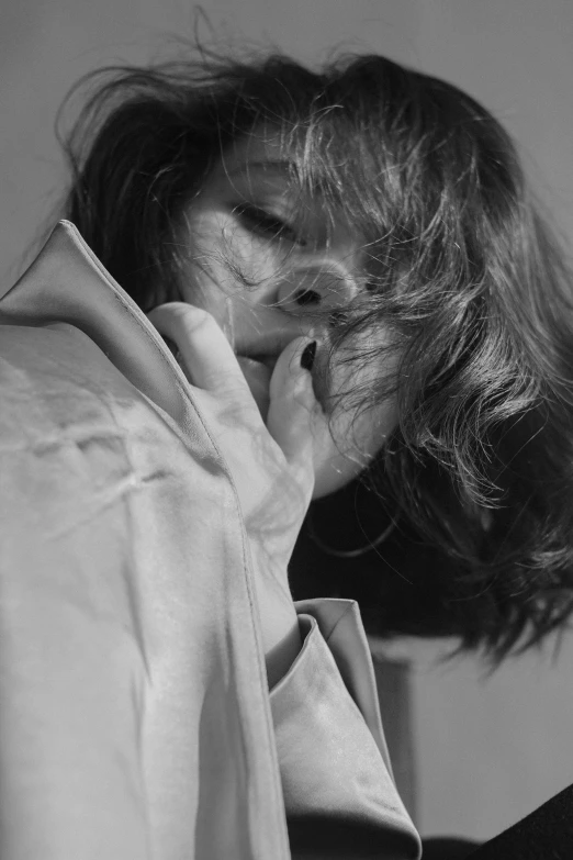a black and white photo of a woman talking on a cell phone, a black and white photo, by Ai-Mitsu, unsplash, photorealism, touching her clothes, soft hair, obscured face, jinyoung shin