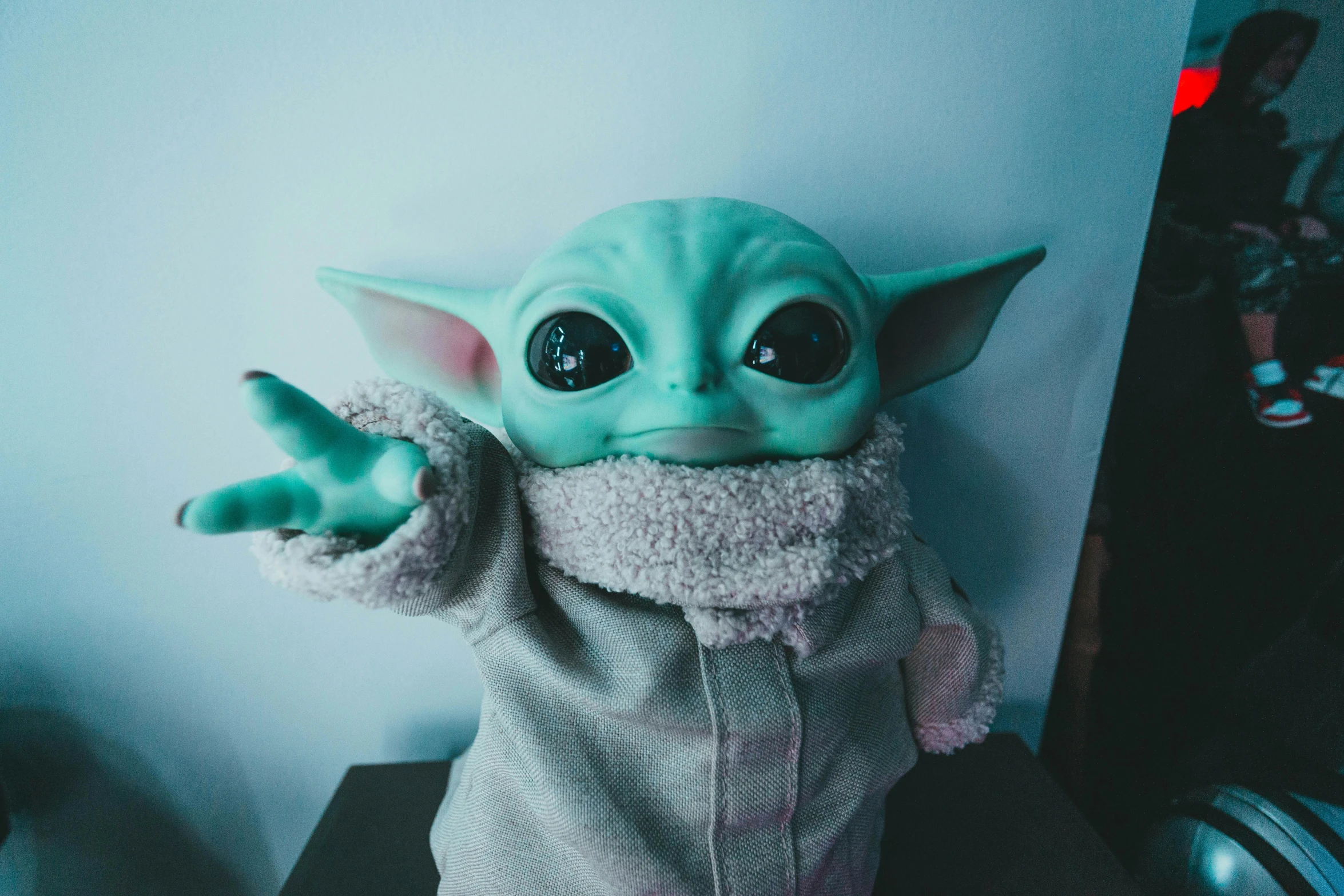 a close up of a stuffed baby yodah, pexels contest winner, pop surrealism, star wars movie, waving at the camera, beeple colors, high quality photo