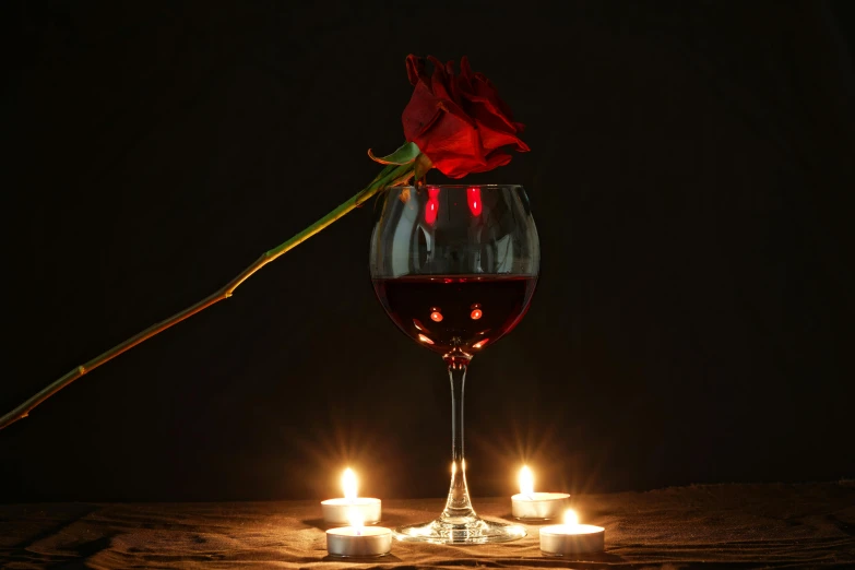 a red rose sitting on top of a glass of wine, holding a candle holder, profile image, fan favorite, lights on