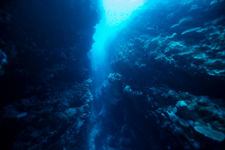 a deep blue water filled with lots of rocks, under the sea, narrow passage, red sea, great barrier reef