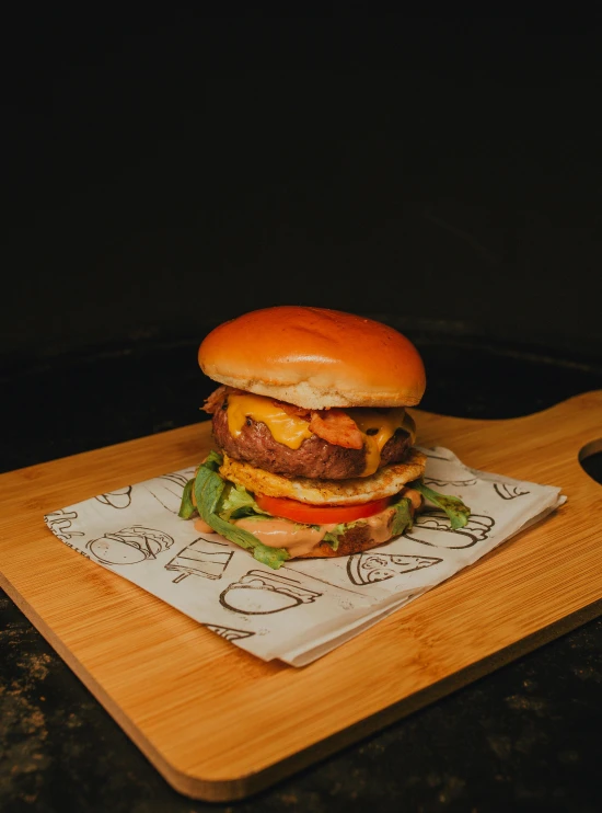 a hamburger sitting on top of a wooden cutting board, profile image